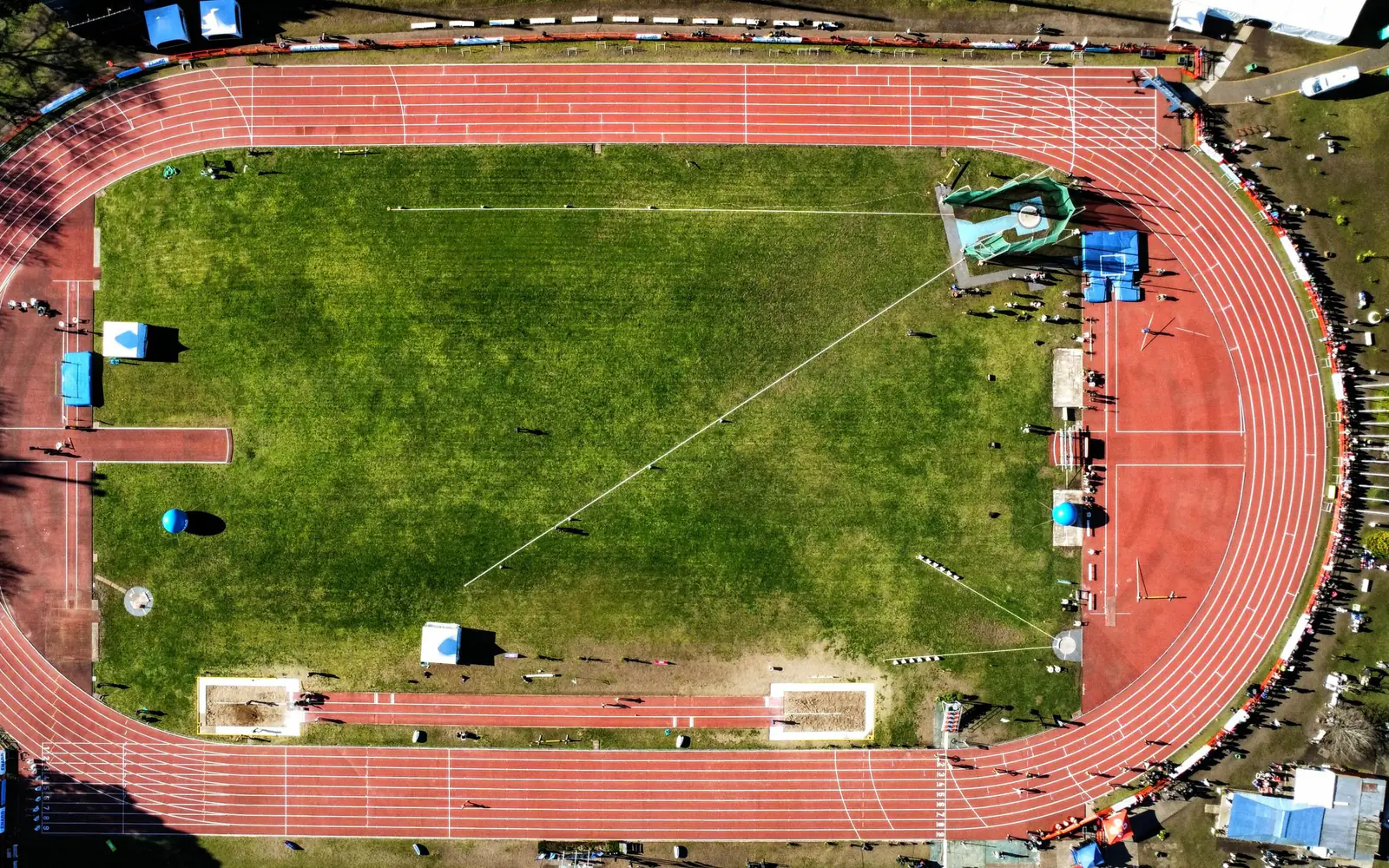 An aerial view of an athletics track around a playing field
