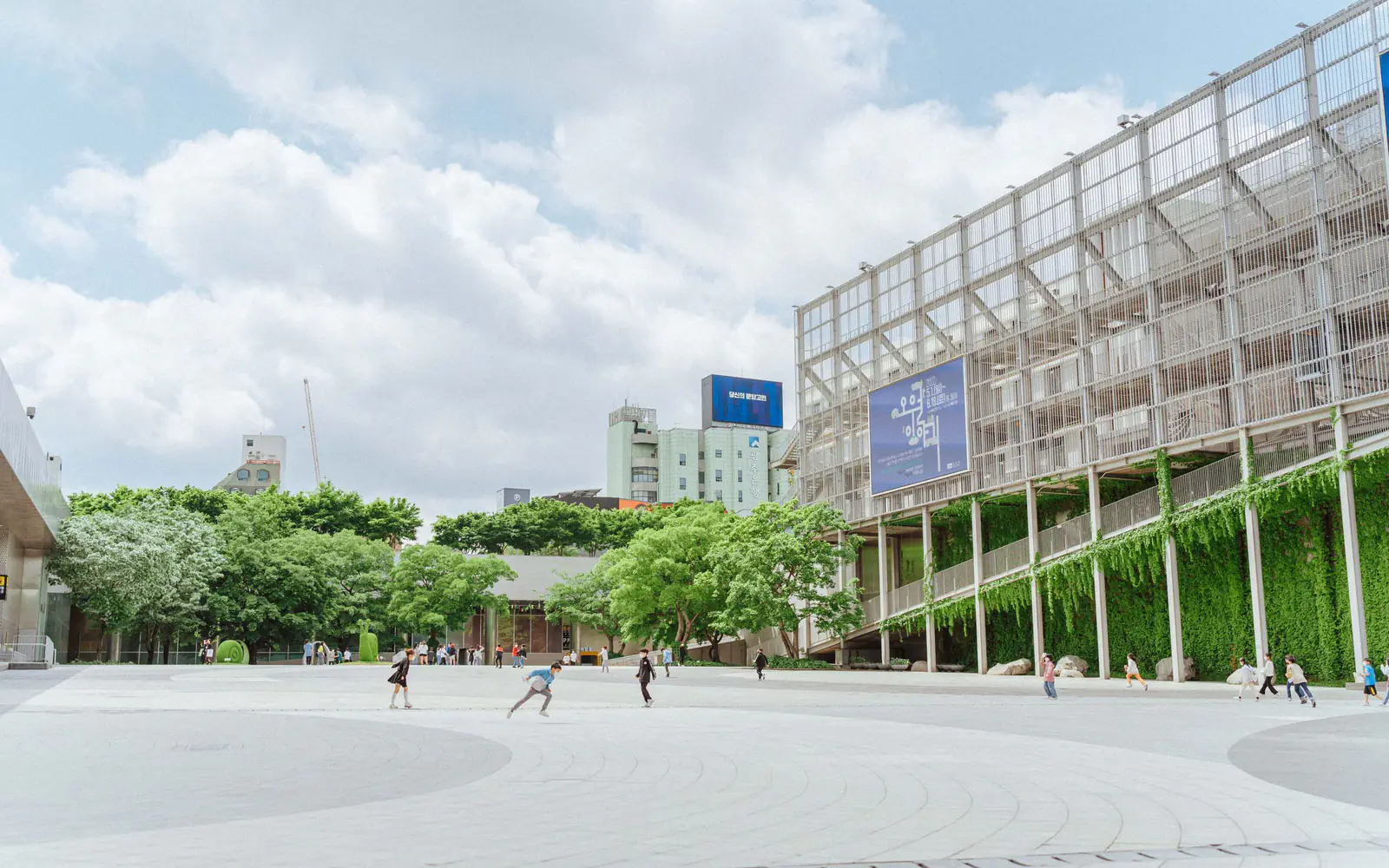 An open urban square framed by modern architecture and planting