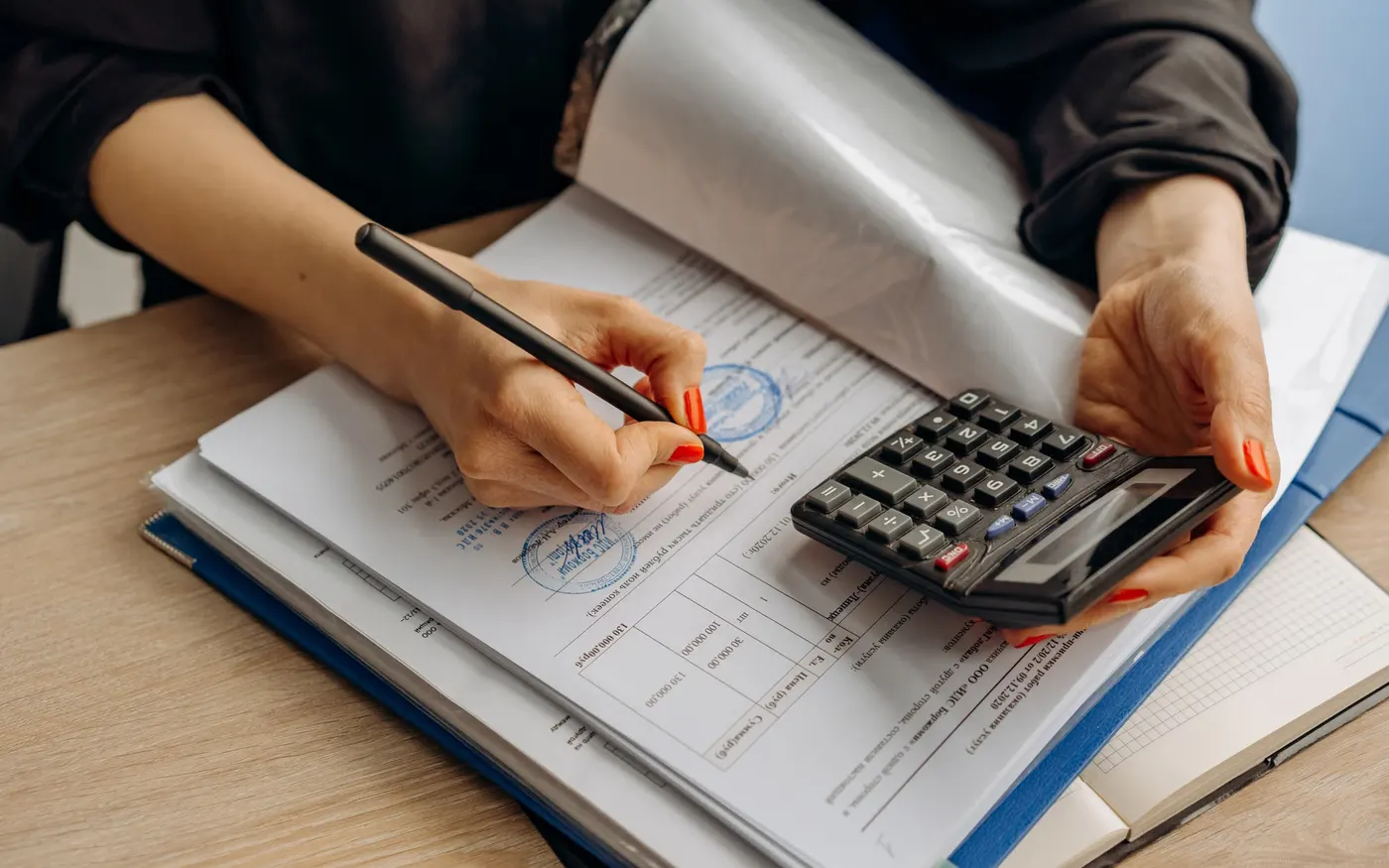 Bound ledgers and financial documents on a desk