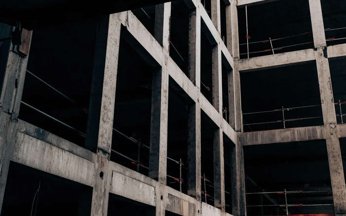 The unfinished concrete frame of a stalled building