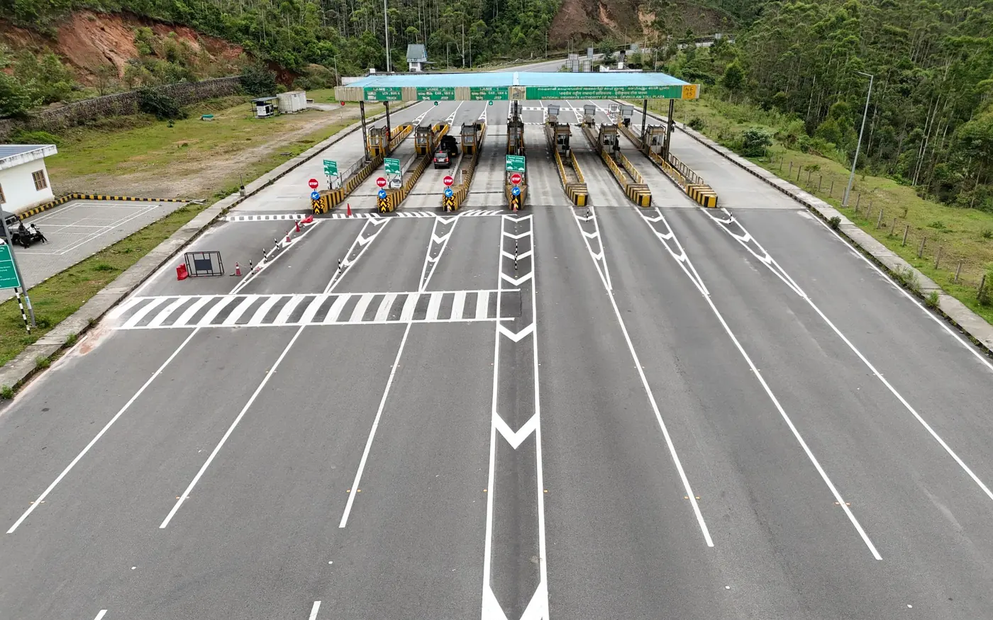 A highway toll plaza seen from the approach lanes